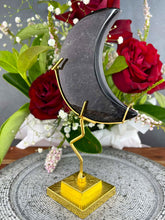 Load image into Gallery viewer, Beautiful Silver Sheen Obsidian Crescent Moon On Gold Stand